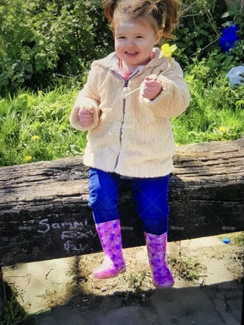 Alia Grace sitting log bench