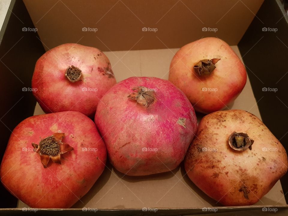 Pomegranate fruits in a box