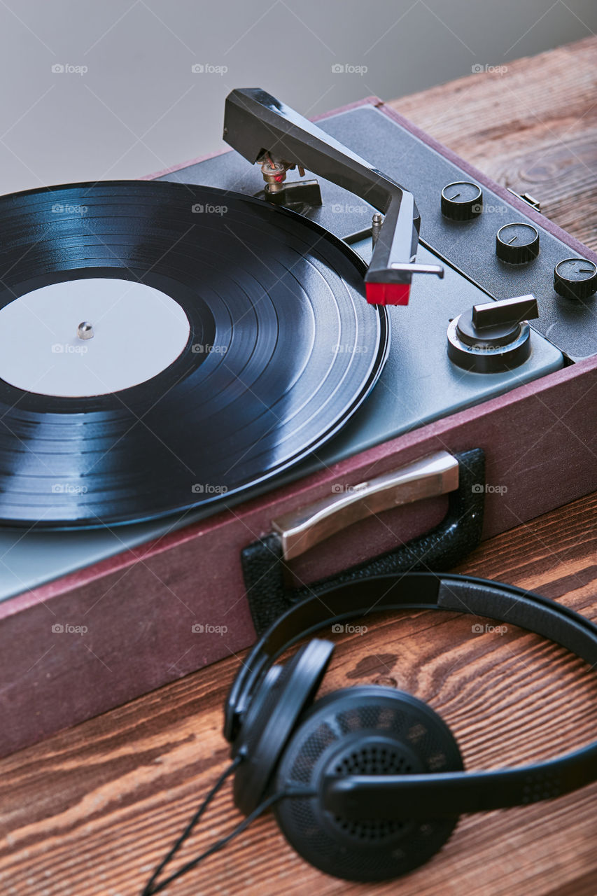 Turntable vinyl player with black vinyl record. Classic stereo set. Candid people, real moments, authentic situations