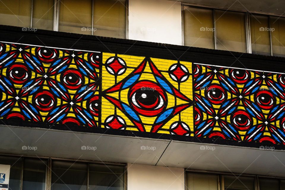 Eye painting on a second floor balcony 