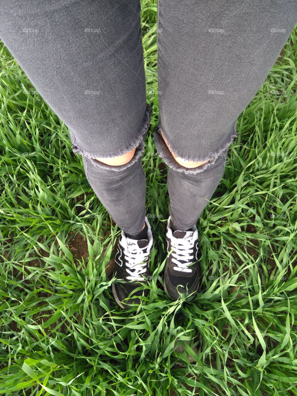 female legs shoes top view green grass summer background