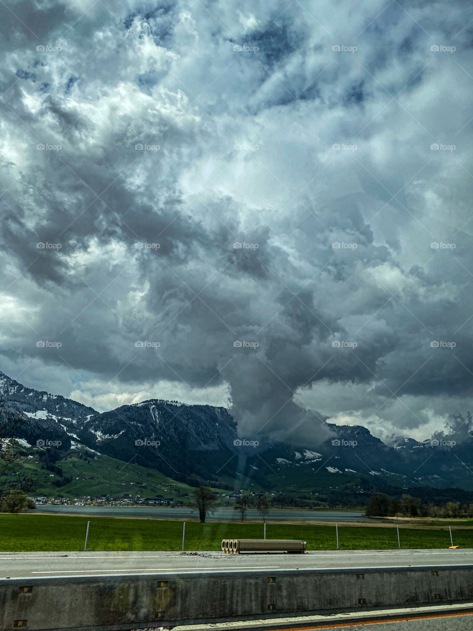Swiss beauties, Swiss mountains, clouds floating over the Alps, railway, stop, bus, beautiful painted building, road