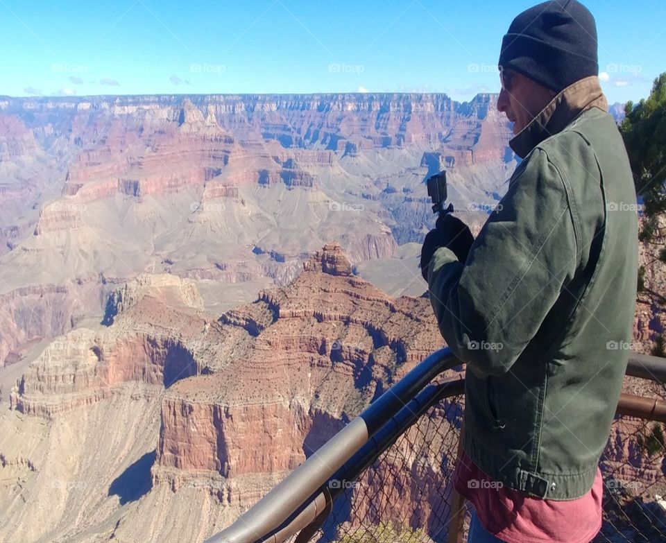 okay this is my husband on the edge of the Grand Canyon I couldn't stand on the edge because I'm scared of heights and the wind was blowing about 50 miles an hour yeah that was it