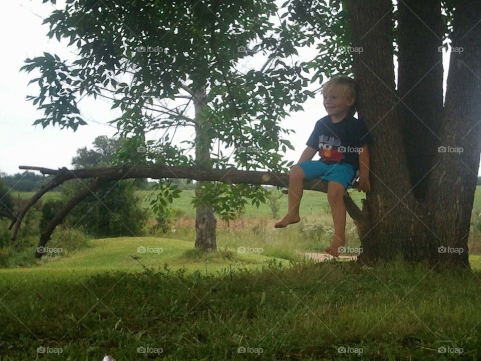 wesleigh sitting by tree