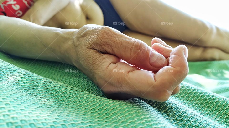 woman's hand on a green mat