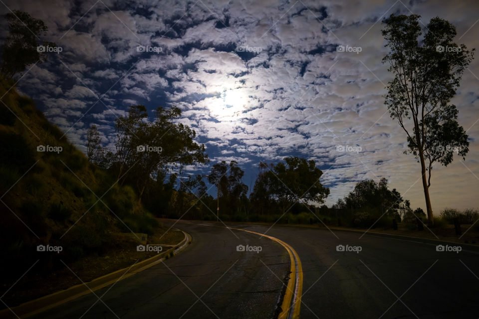 Night road and cloudy sky with moon light 