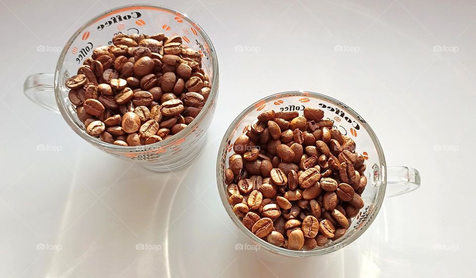 cups of coffee beans close up on a white background, top view, love coffee