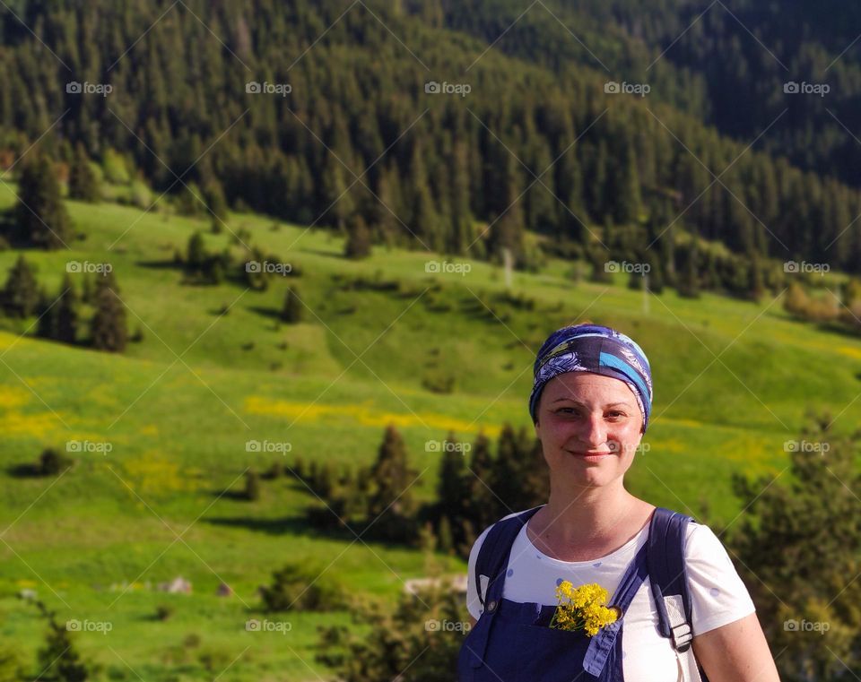 Smiley woman in the green mountains