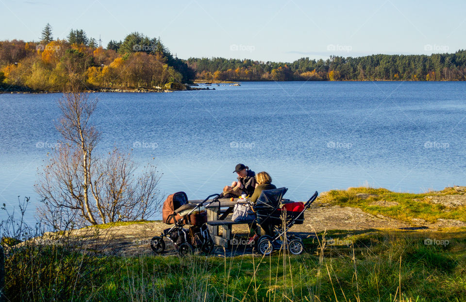 Family picnic by the lake. 