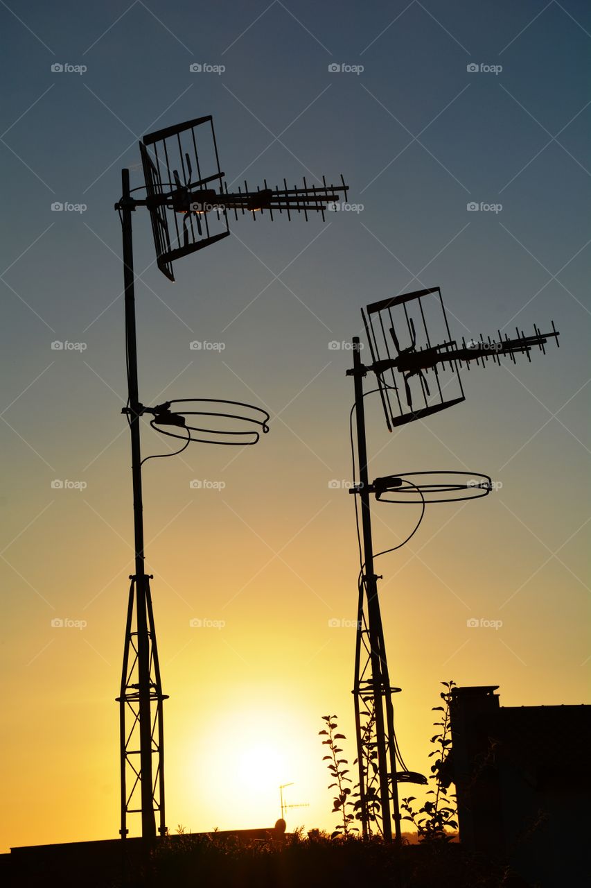 two antennas in the sunset