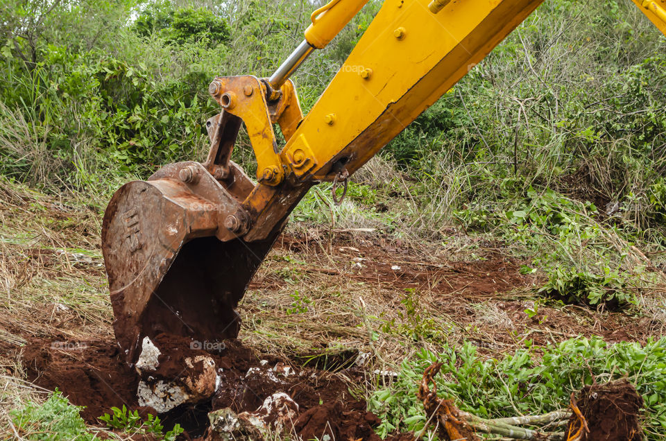 Backhoe Bucket Digging In The Ground