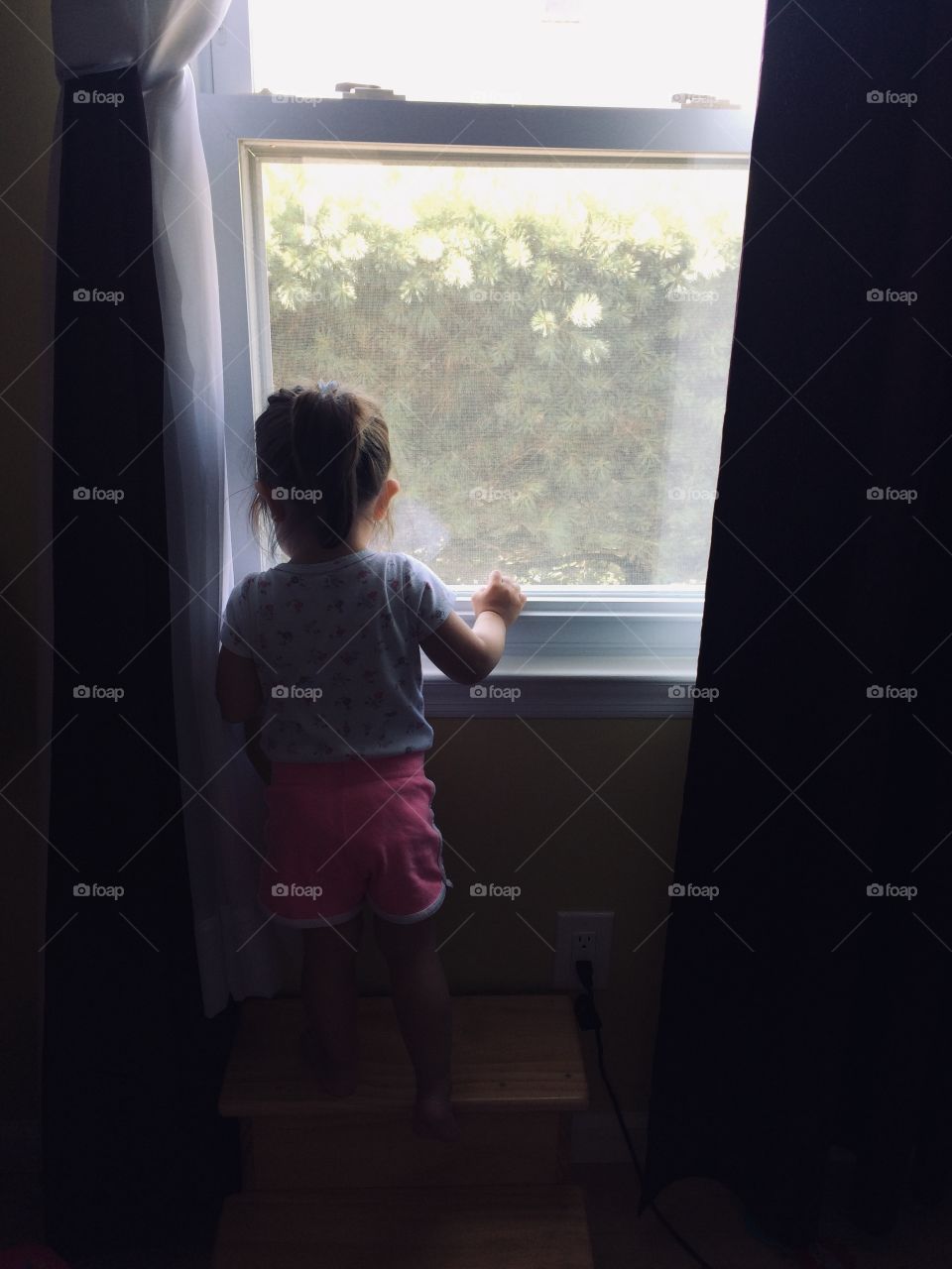 Little girl staring out the window