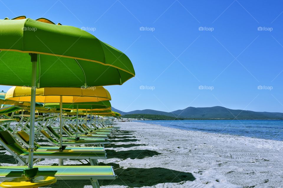 View of lounge chairs on beach