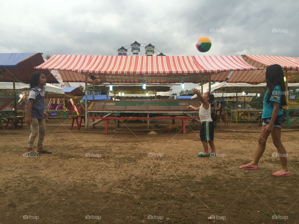 Kids playing ball at an amusement park