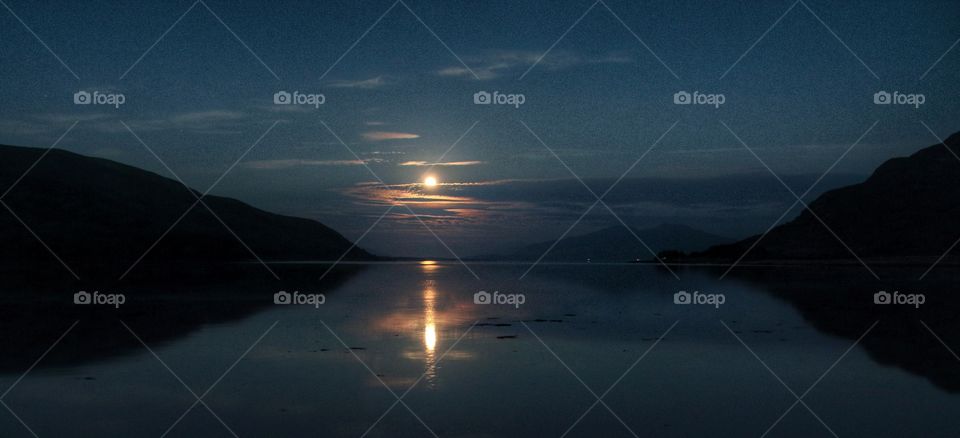 Reflection of sunrise in idyllic lake