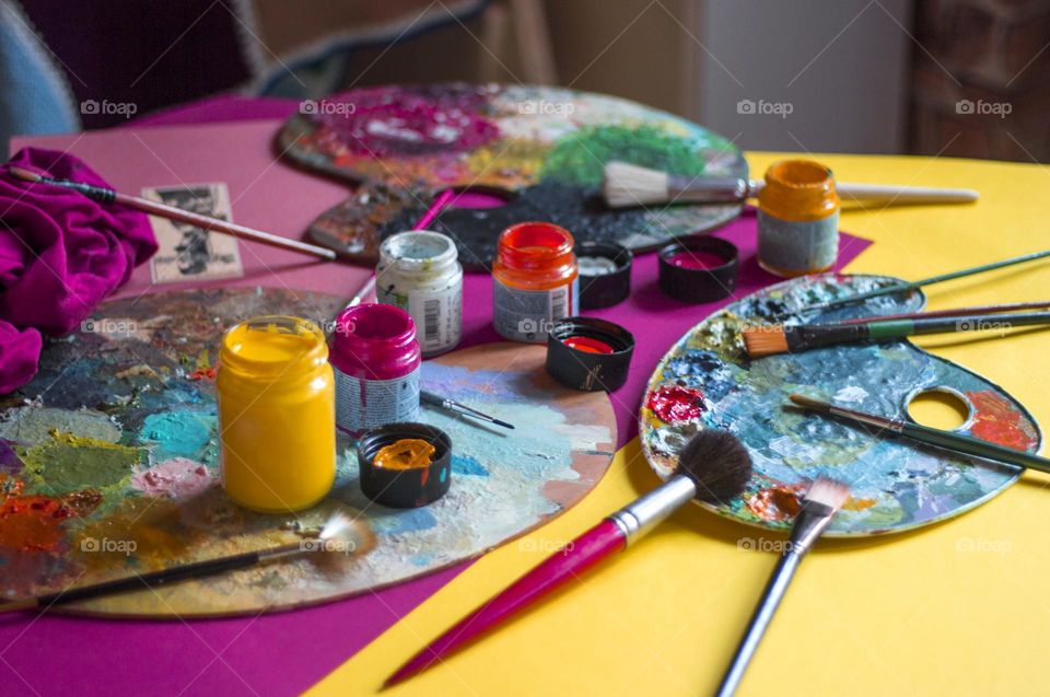 Colorful acrylic paint and brushes on the table