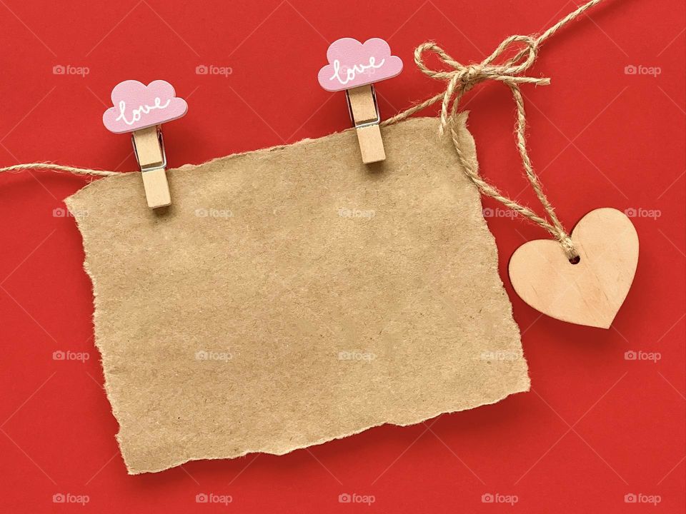 Kraft paper, wooden heart, clothespins and rope
