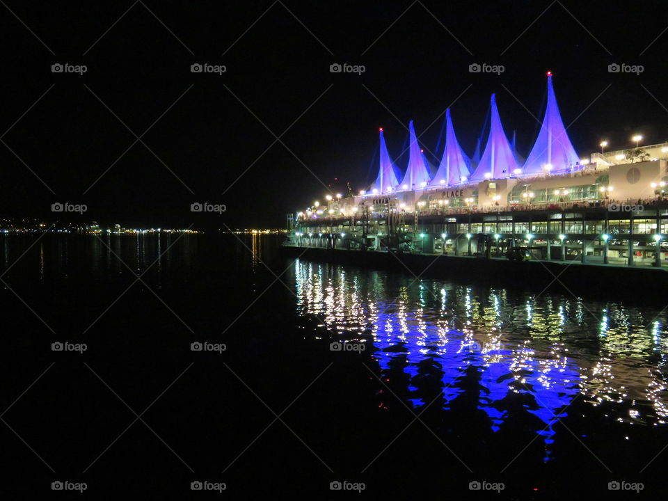 blue lamps reflecting into the water in the night