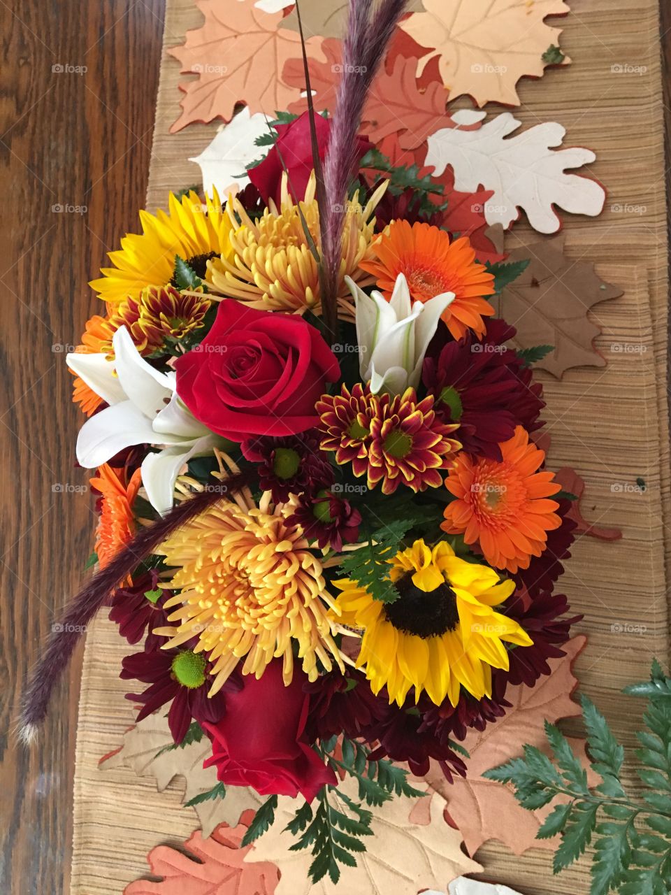 Thanksgiving centerpiece, cornucopia, sunflowers, chrysanthemum, white lilies, red roses, orange Gerber daisies. Abundance, joyful, Thanksgiving. 