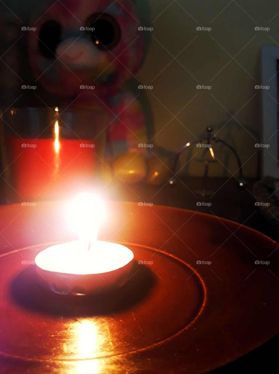 lit candle lighting bedside table