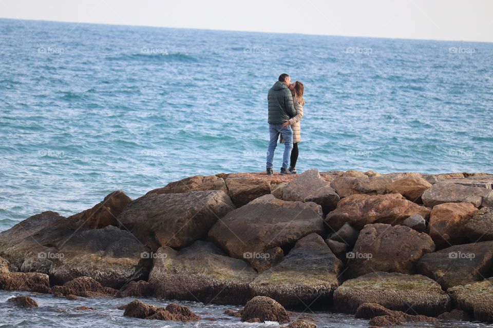 Couple kissing at the shore