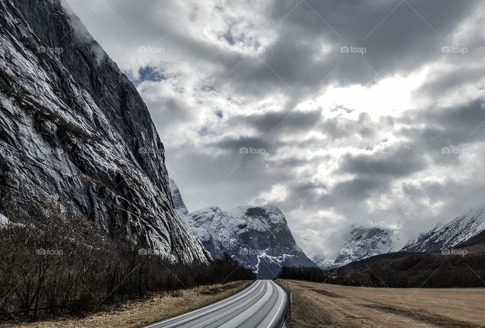 Empty road along with mountains