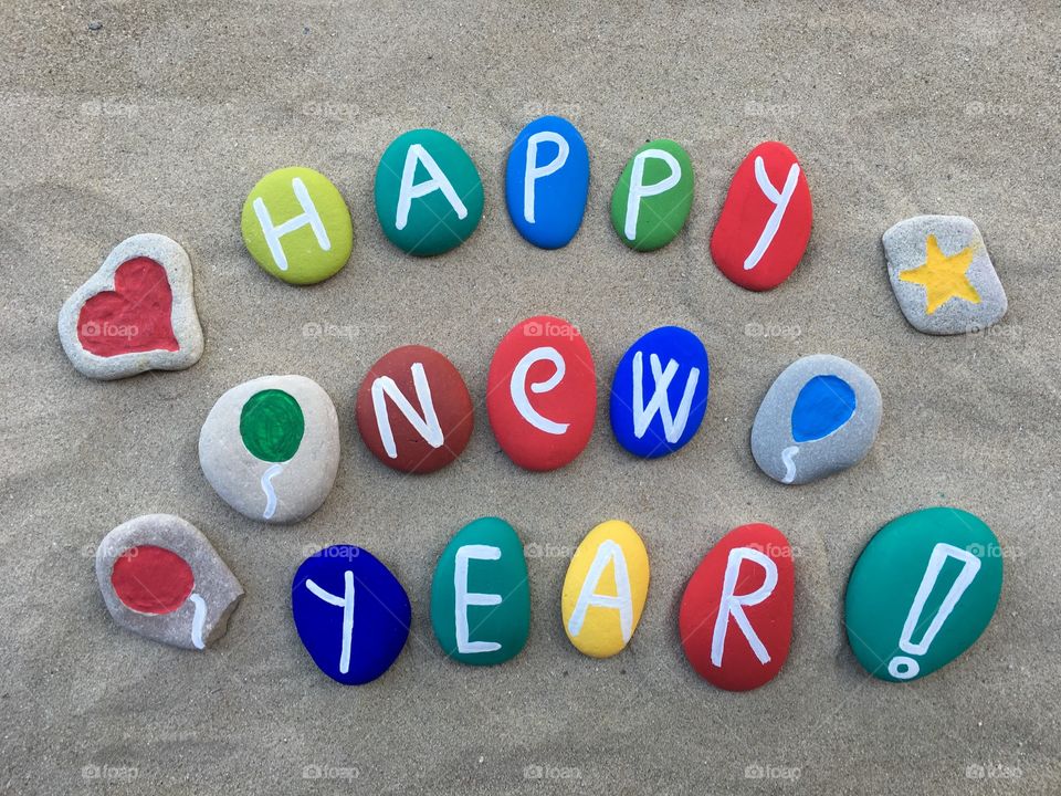 Painted pebble with text on the beach