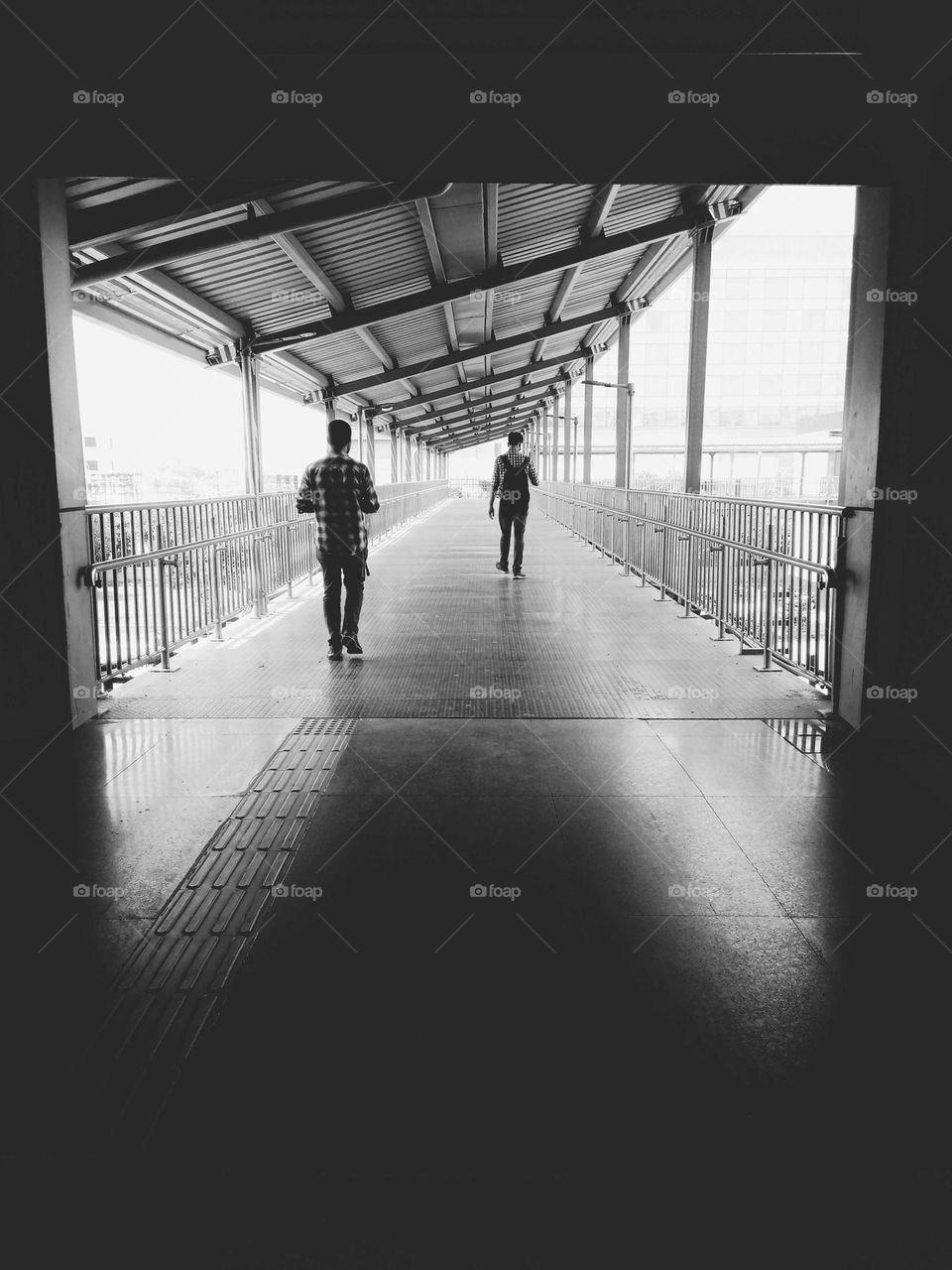person crossing the road via overbridge.