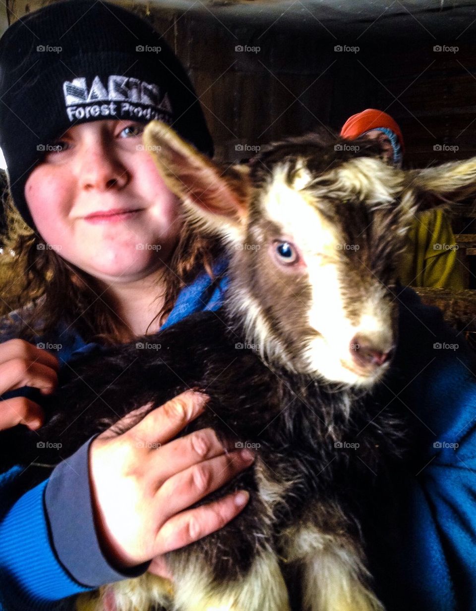Girl Holding a Baby Goat