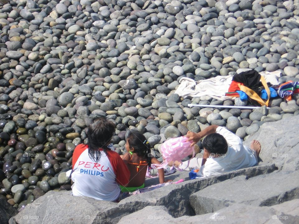 Family Day at the Beach. A rocky beach in Lima