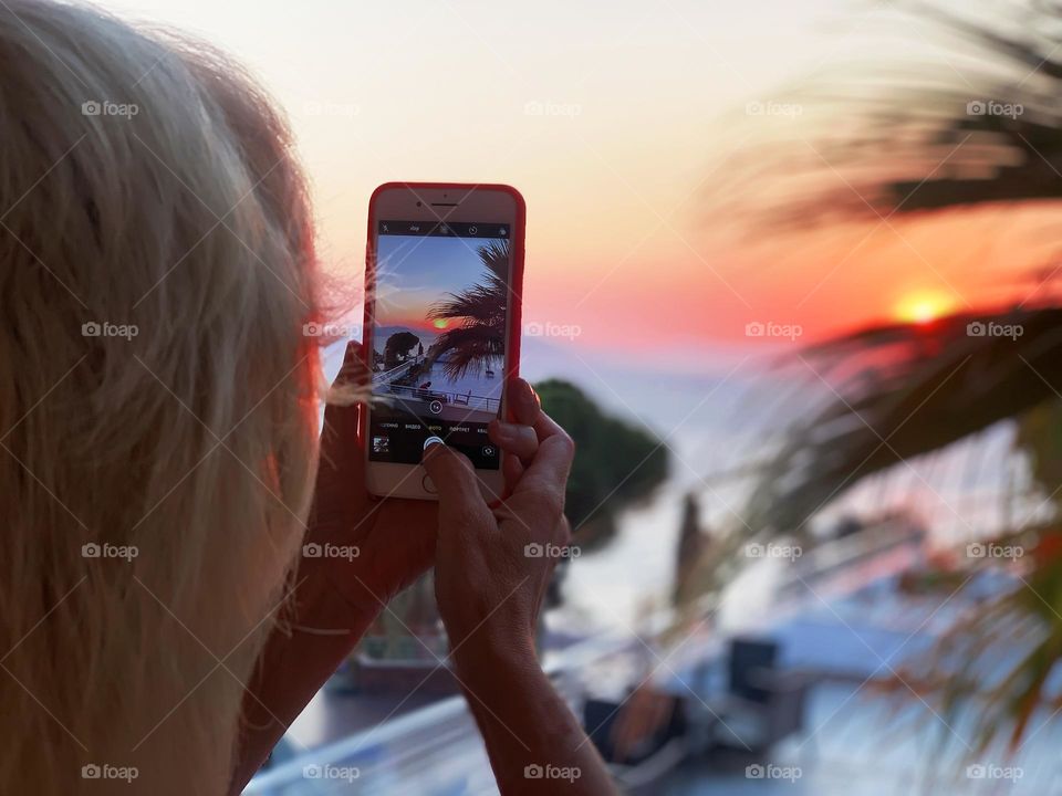 Taking a photo of a tropical sunset 