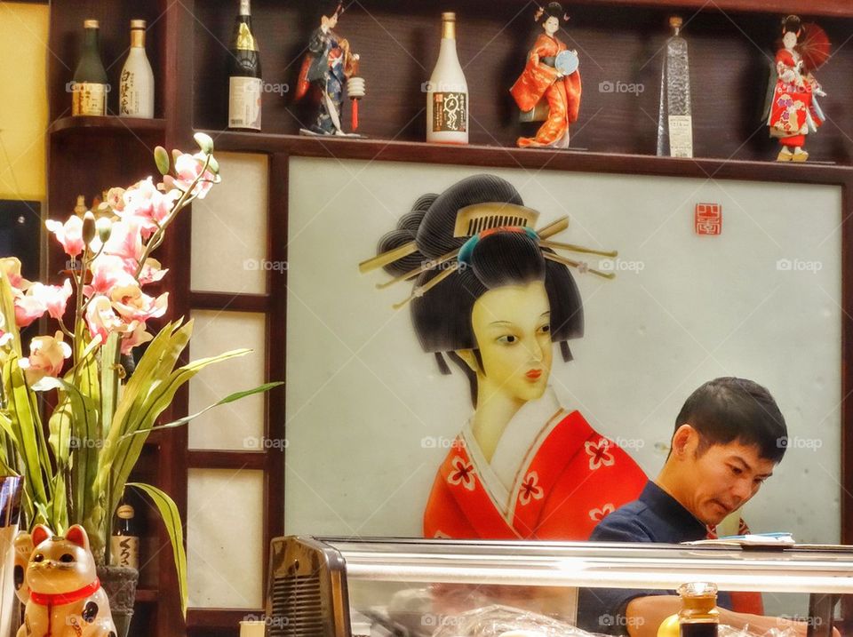 Sushi Chef At Work. Preparing Sushi In A Japanese Restaurant
