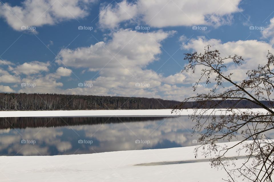 reservoir in winter with sky reflection