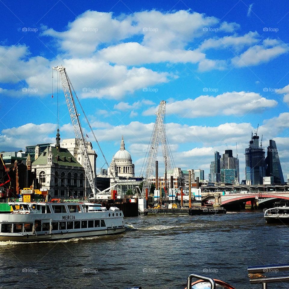 london skyline showing the city and stpauls from the river Thames on a sunny June day