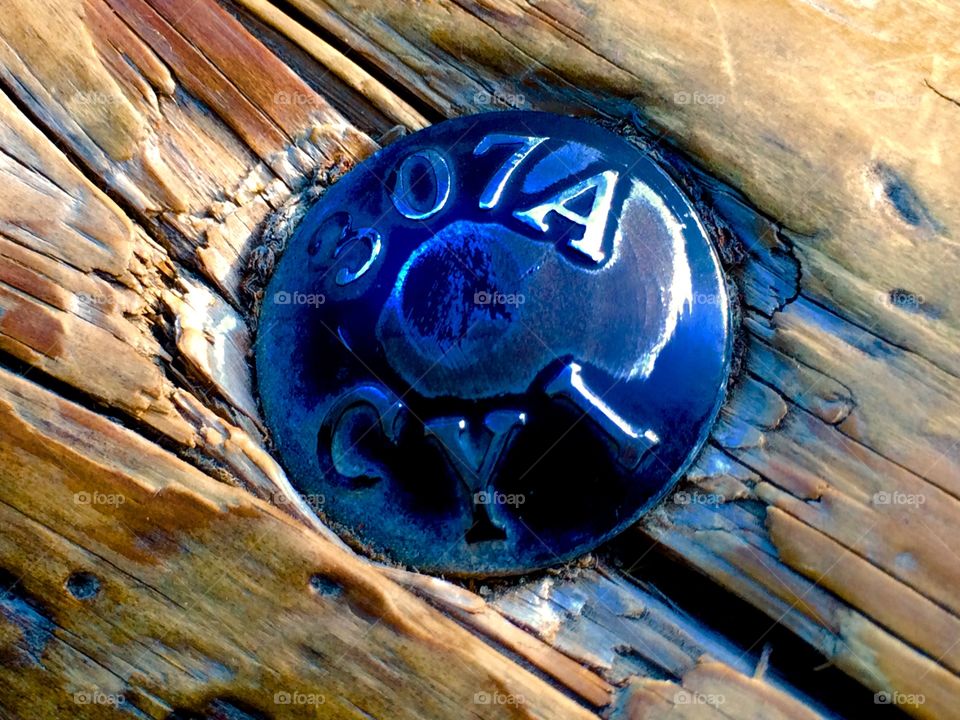 Close up of bolt in wooden railing