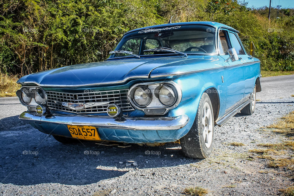 Beautiful blue retro car on a road