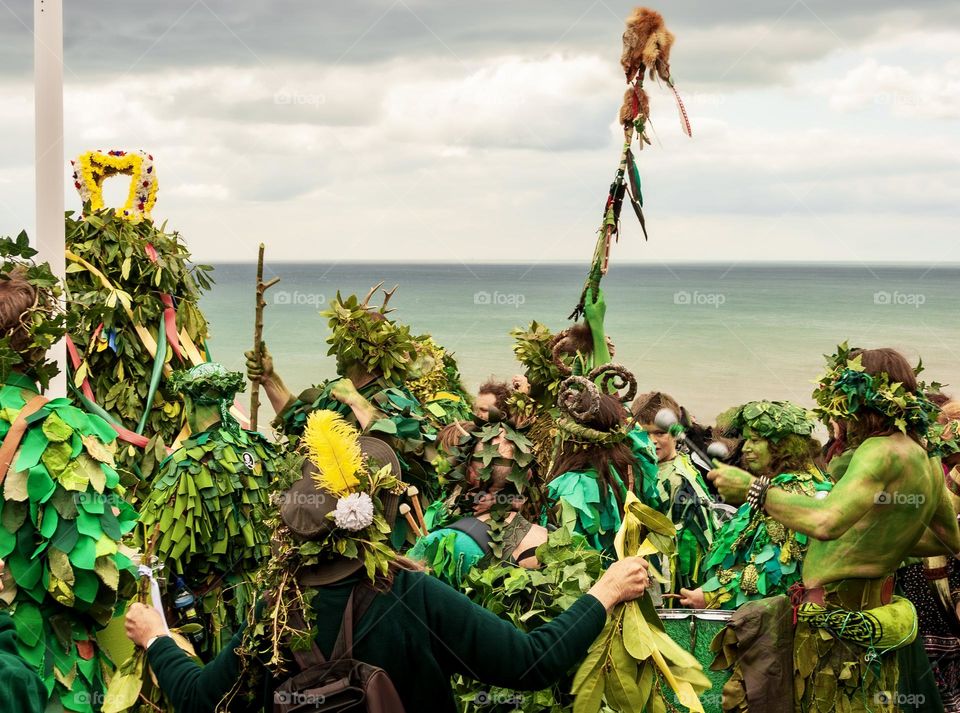 People dressed in green, celebrating Beltane in the seaside town of Hastings, UK