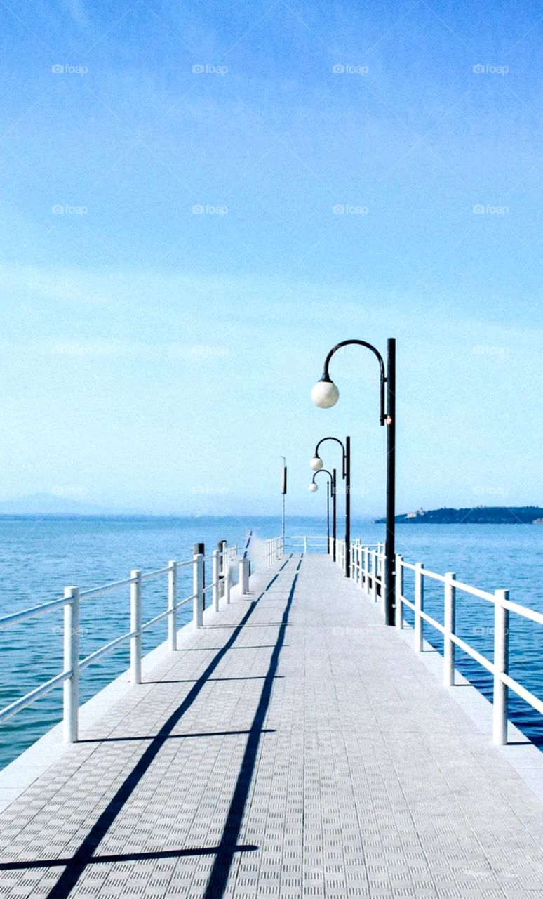 so nice clean photo of bridge with street light nice path on seashore