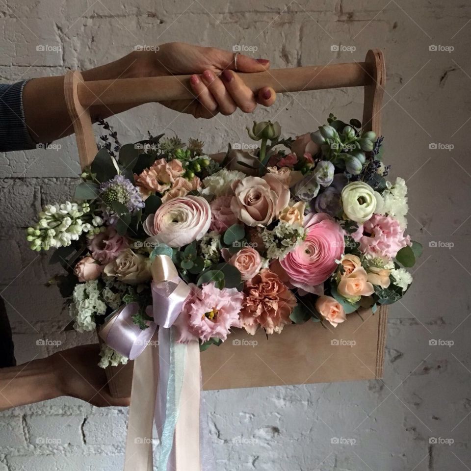 Box of flowers in hands