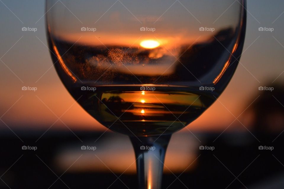 Sunset through a glass of wine 