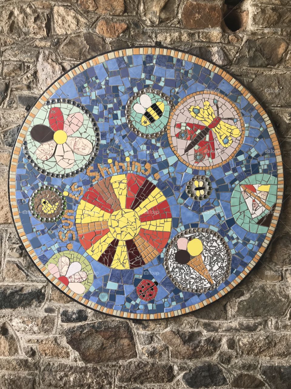 This mosaic appears to focus on creating art via shapes, The outcome leaves the viewer an opportunity to imagine what the artists thoughts were. what do you think?