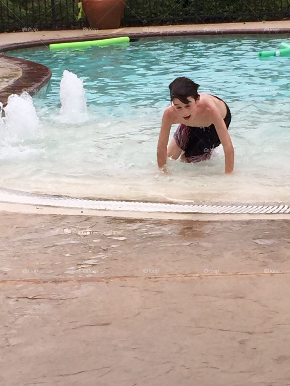 Young man enjoying at swimming pool