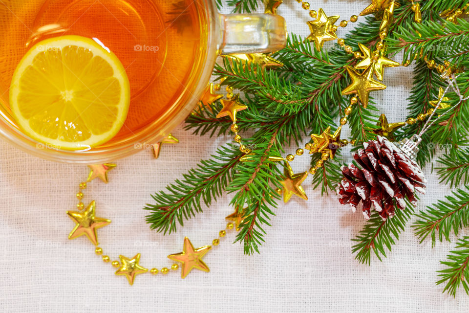 High angle view of lemon tea near christmas ornaments