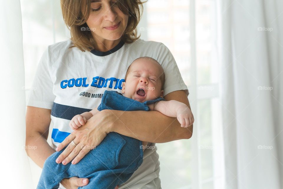 beautiful mother and six-month-old son, tender family photos, family spending time at home