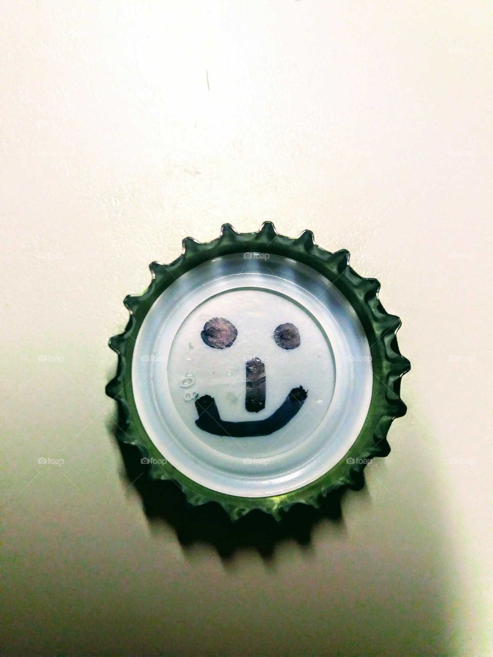 smiling face on bottlecap