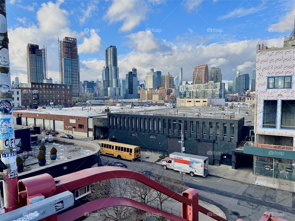 This is the view from the top of the staircase of the “Pulaski Bridge” at “Newtown Creek” on the “Greenpoint”, Brooklyn side of the bridge. In the distance we see “Manhattan” with its various skyscrapers. 2023. Hypnotic Productions