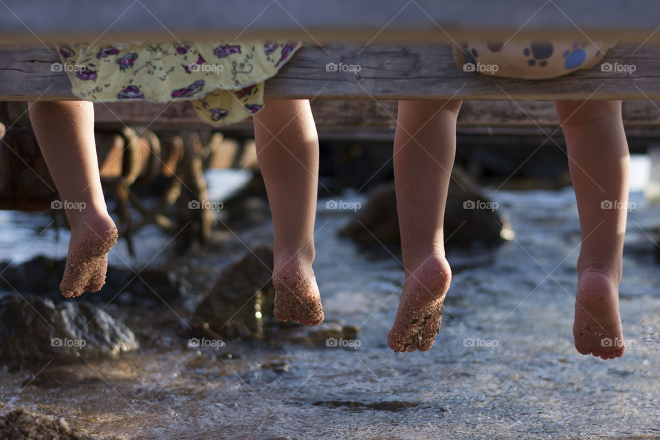 feet above water. children's feet above water