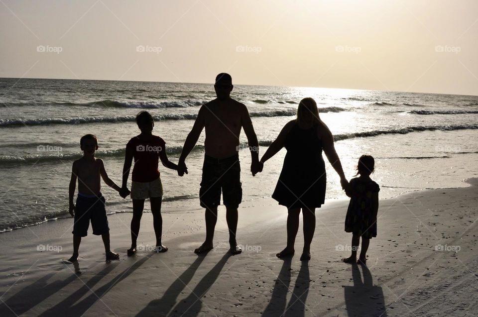 Family silhouette on the beach