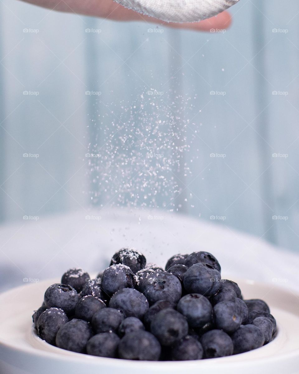 Blueberries with a dusting of sweetness and a blue barn wood background 