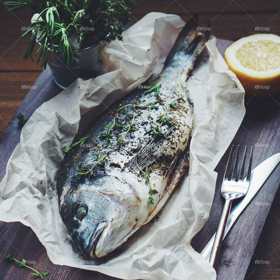 Baked fish on wooden table
